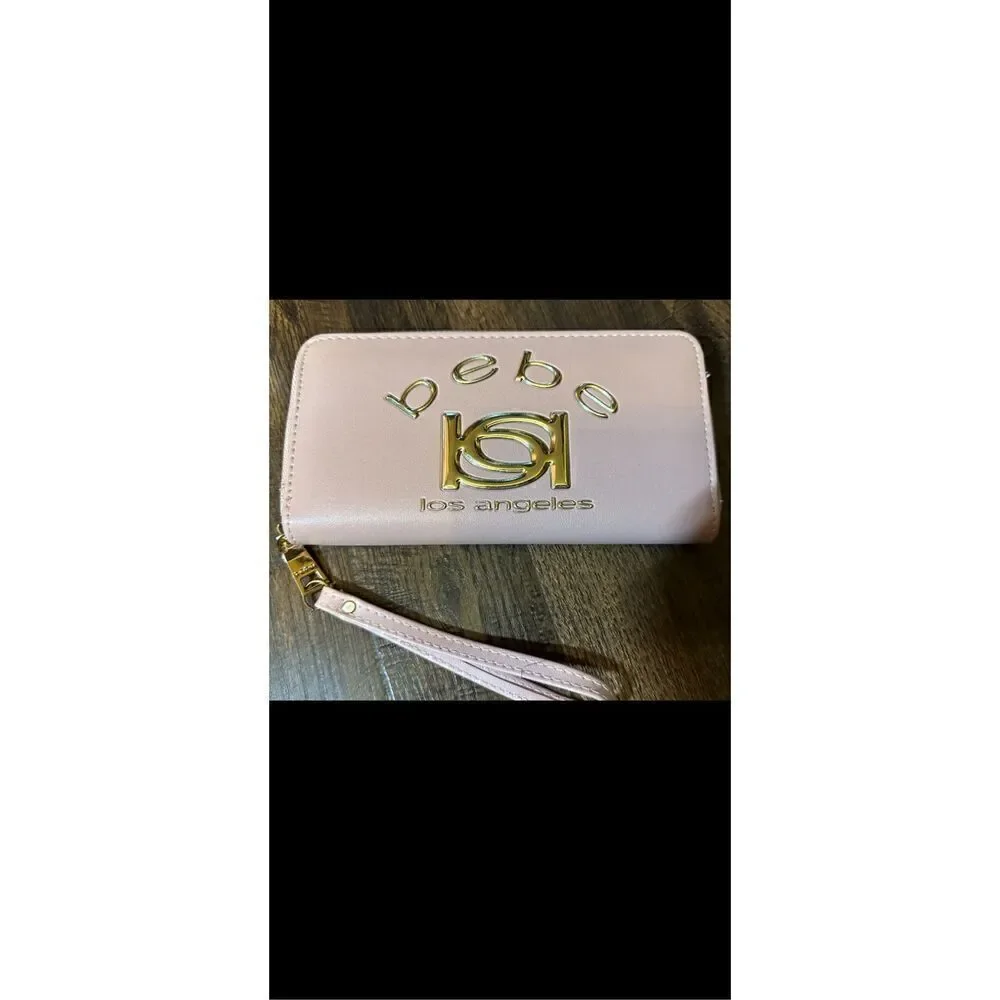 BEBE Pink and gold, large wristlet. Lots of room never used.